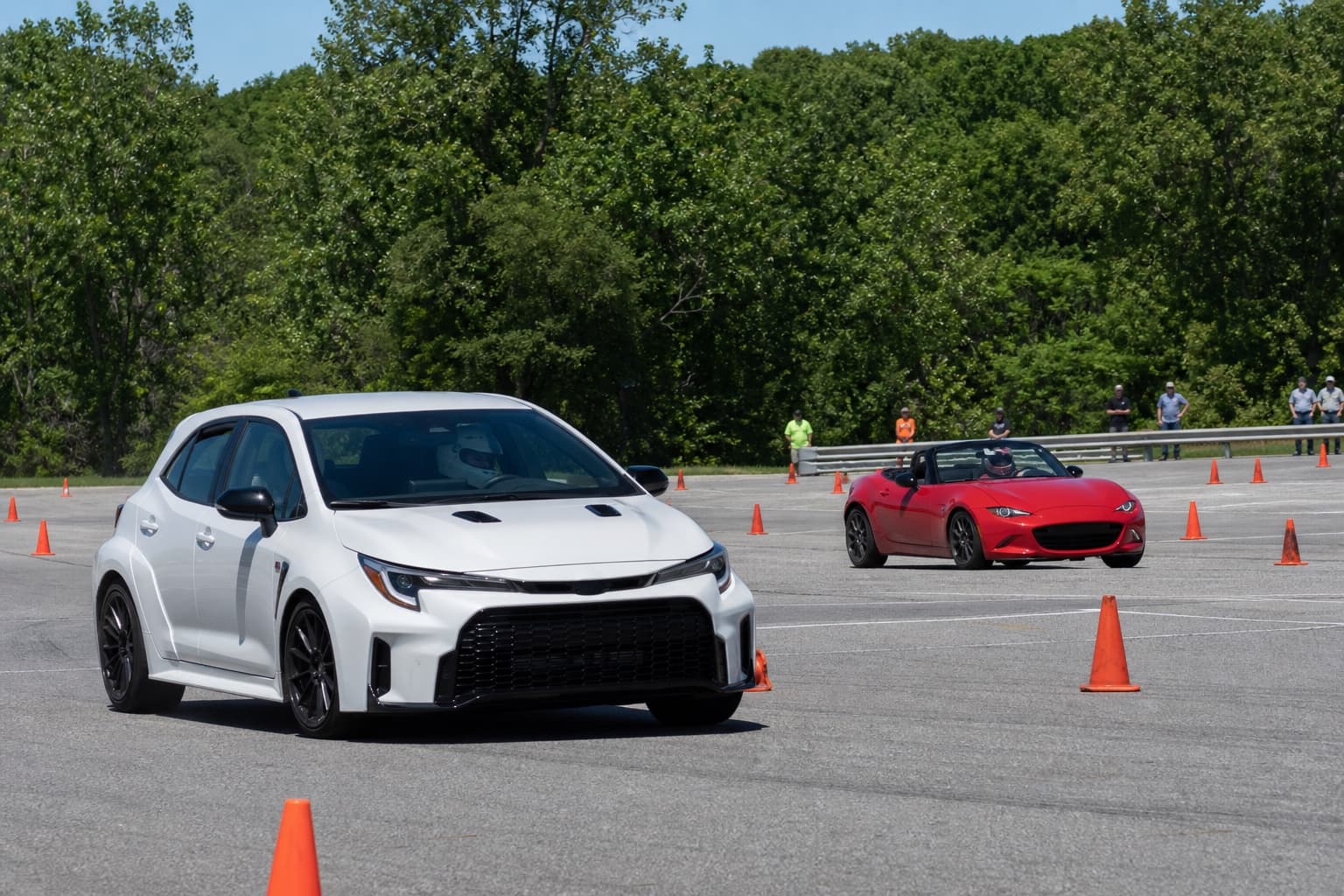 A Toyota performance hatchback and Mazda Miata-style roadster at a grassroots autocross